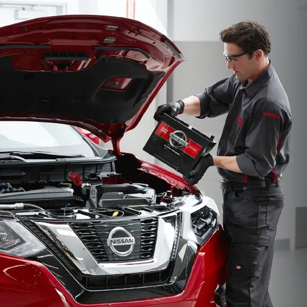techinician putting battery in car