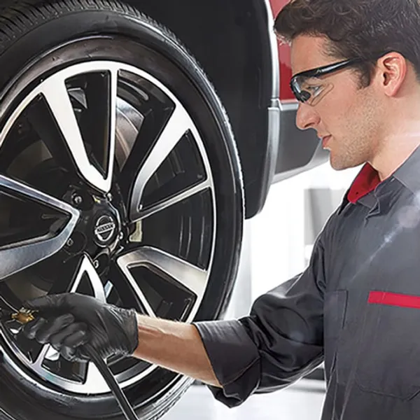technician checking tire pressure